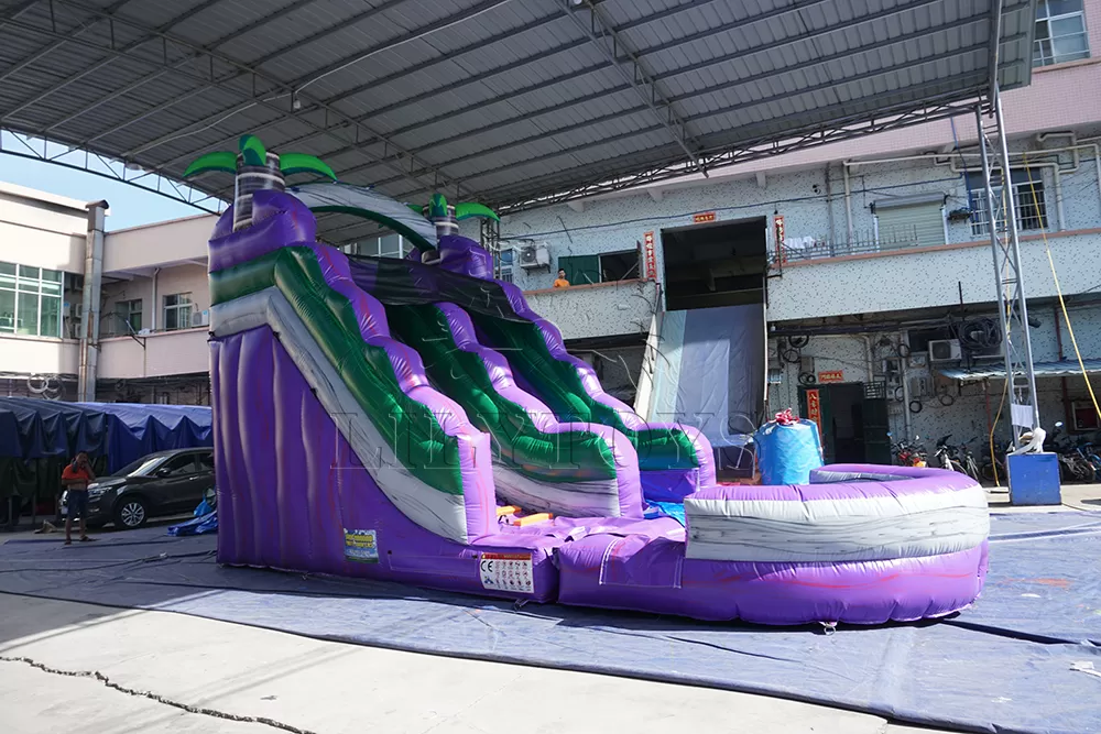 purple inflatable water slide with big pool