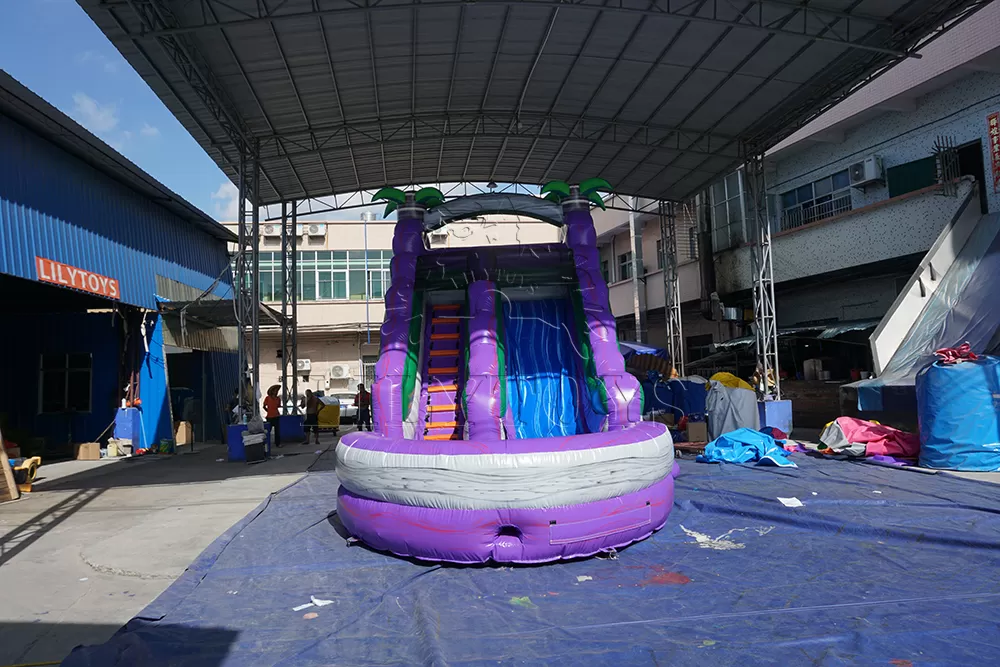 purple inflatable water slide with big pool