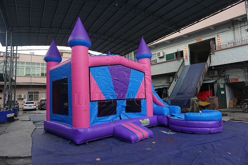 Pink inflatable bounce castle with slide