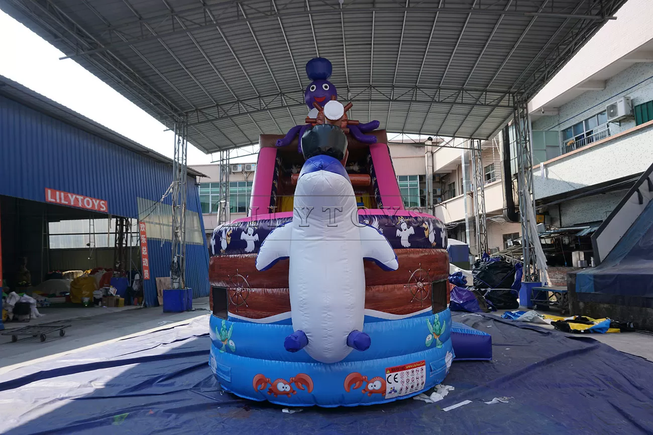 Blown inflatable pirate ship slide with a Dolphin in front