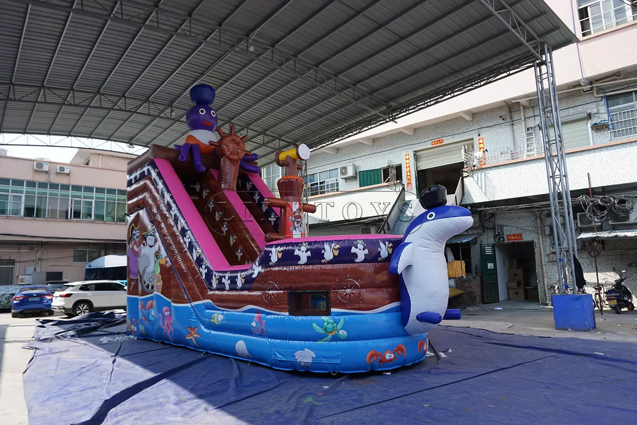 Blown inflatable pirate ship slide with a Dolphin in front