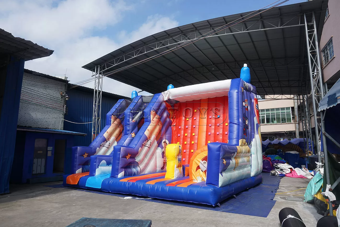 Inflatable dry slide with rock climbing