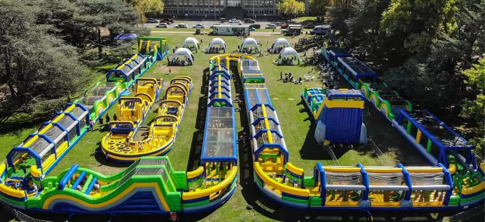 green and blue inflatable blue obstacle course park